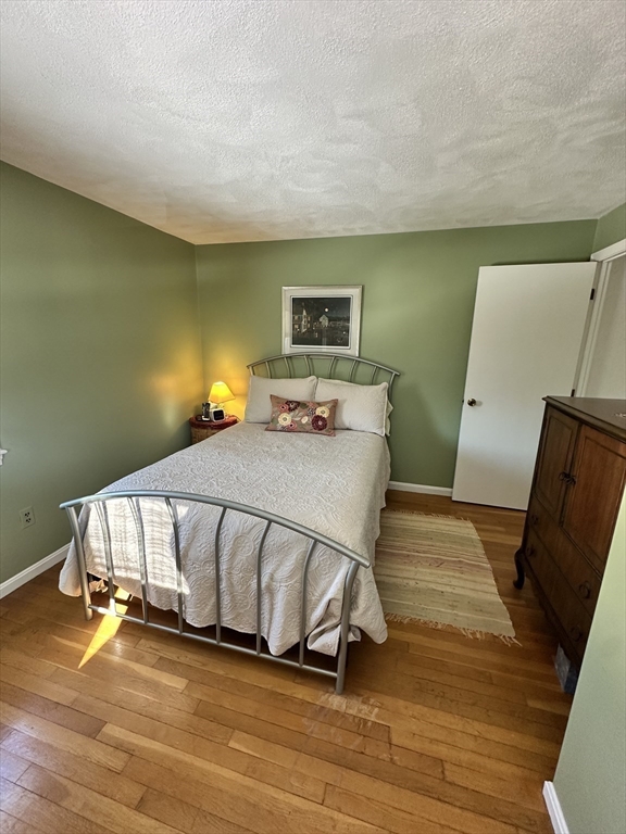 12 Wellington Ln Avenue Lexington, MA 02421 - Photo 12 of 15 a bedroom with a bed and wooden floor