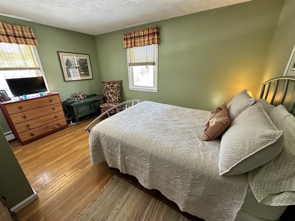 12 Wellington Ln Avenue Lexington, MA 02421 - Photo 13 of 15 a bedroom with a bed and window