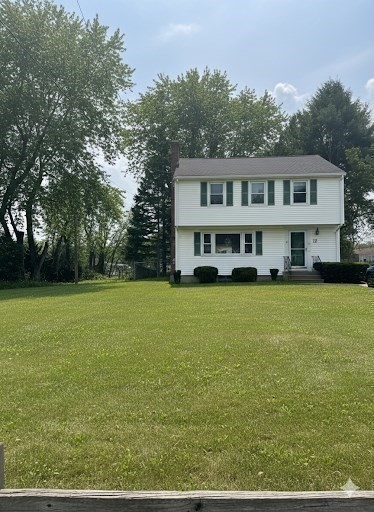 12 Wellington Ln Avenue Lexington, MA 02421 - Photo 3 of 15 a front view of a house with a garden