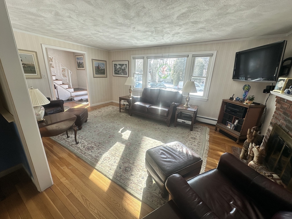 12 Wellington Ln Avenue Lexington, MA 02421 - Photo 4 of 15 a living room with furniture and a flat screen tv