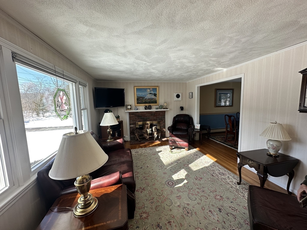 12 Wellington Ln Avenue Lexington, MA 02421 - Photo 5 of 15 a living room with furniture a fireplace and a large window