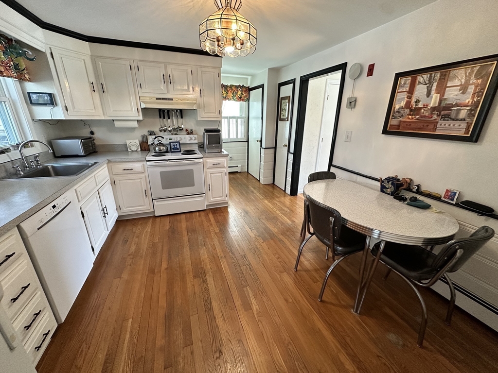 12 Wellington Ln Avenue Lexington, MA 02421 - Photo 6 of 15 a kitchen with wooden floors and white appliances