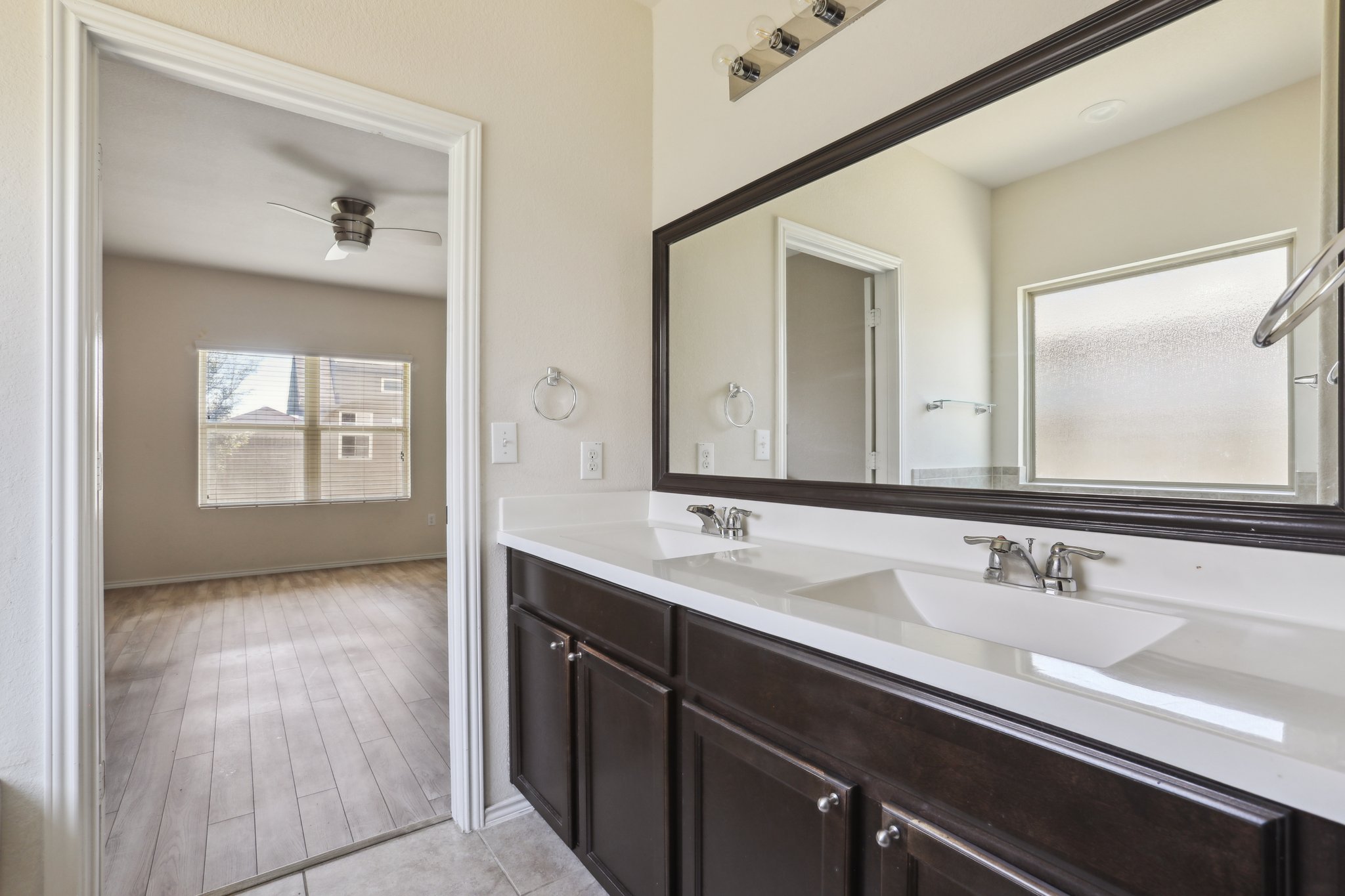 5713 Kennedy Street Austin, TX 78747 - Photo 11 of 30 Full bath with double vanity, plenty of natural light, and ceiling fan