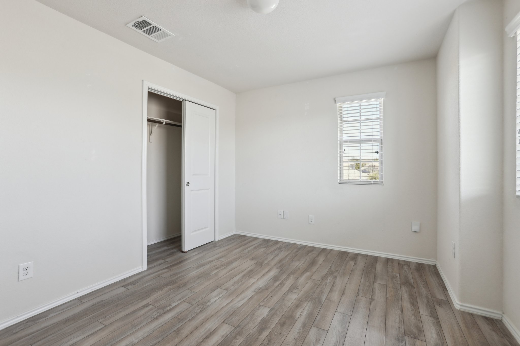 5713 Kennedy Street Austin, TX 78747 - Photo 14 of 30 Unfurnished bedroom with wood finished floors and a closet