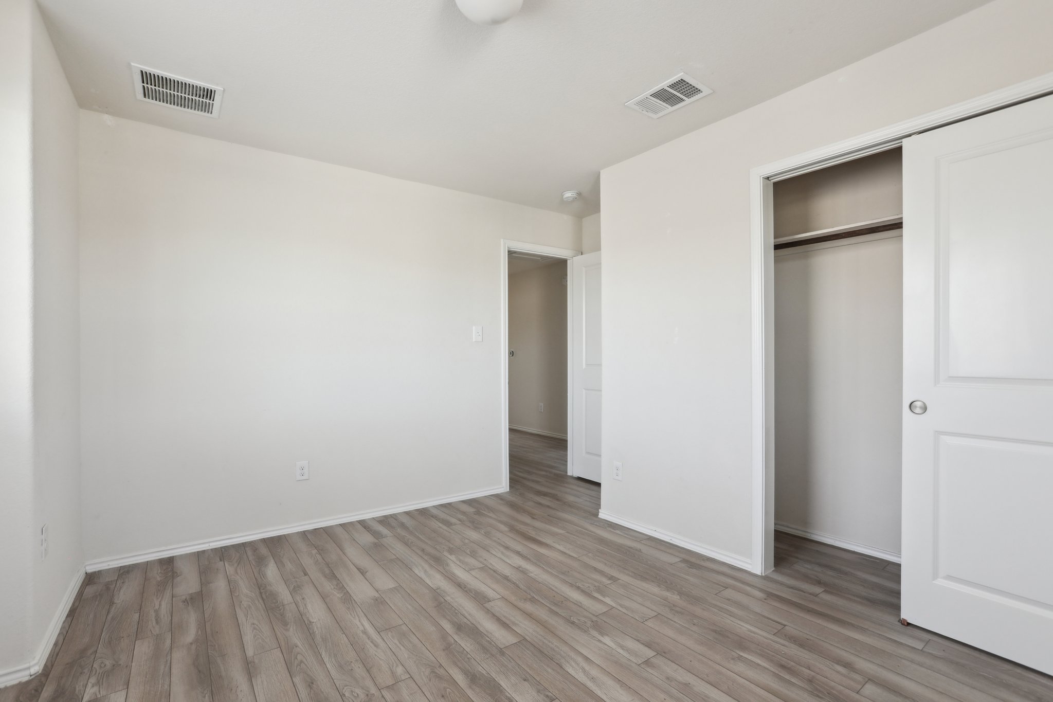 5713 Kennedy Street Austin, TX 78747 - Photo 15 of 30 Unfurnished bedroom featuring light wood-style flooring and a closet