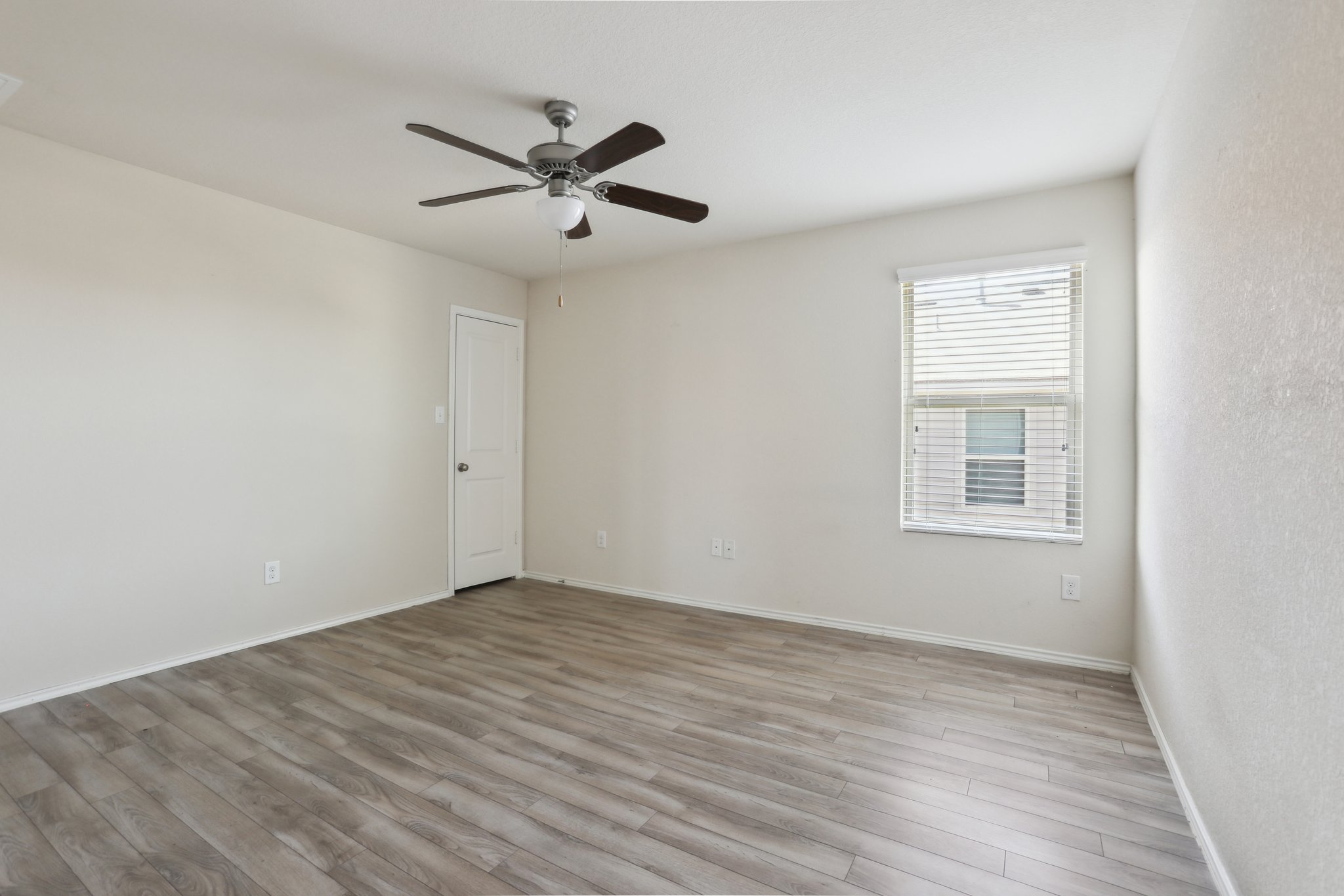 5713 Kennedy Street Austin, TX 78747 - Photo 16 of 30 Empty room with light wood finished floors and a ceiling fan