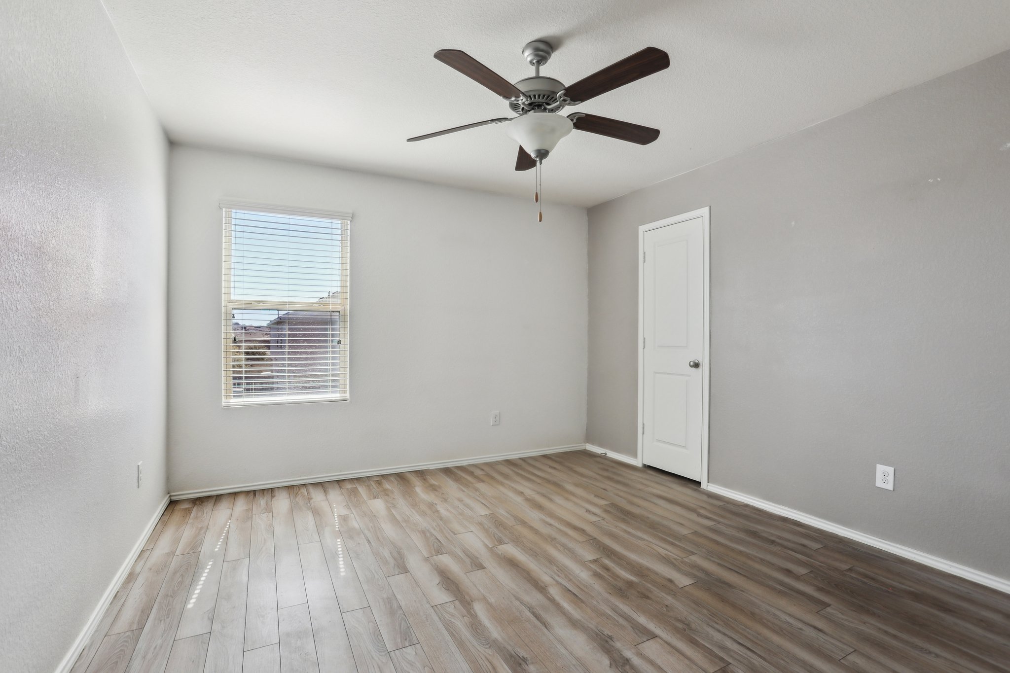 5713 Kennedy Street Austin, TX 78747 - Photo 20 of 30 Empty room with a ceiling fan and wood finished floors