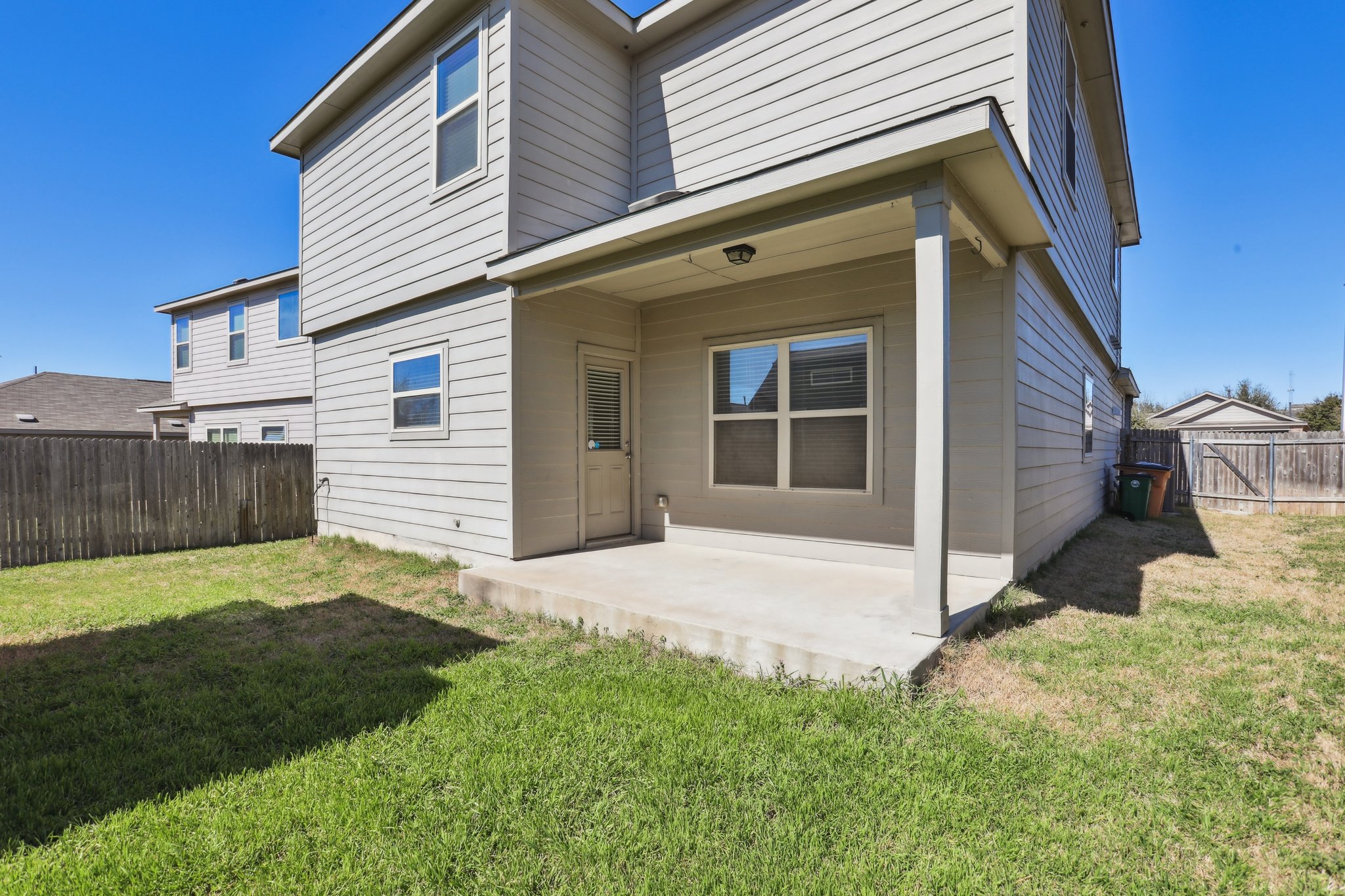 5713 Kennedy Street Austin, TX 78747 - Photo 22 of 30 Back of property with a patio area and a fenced backyard