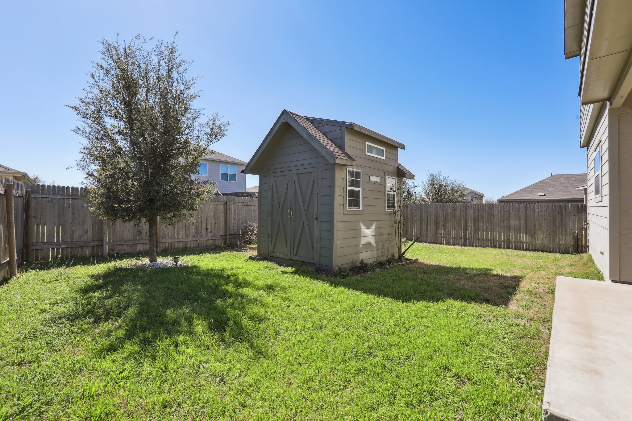 5713 Kennedy Street Austin, TX 78747 - Photo 23 of 30 Fenced backyard with a storage unit