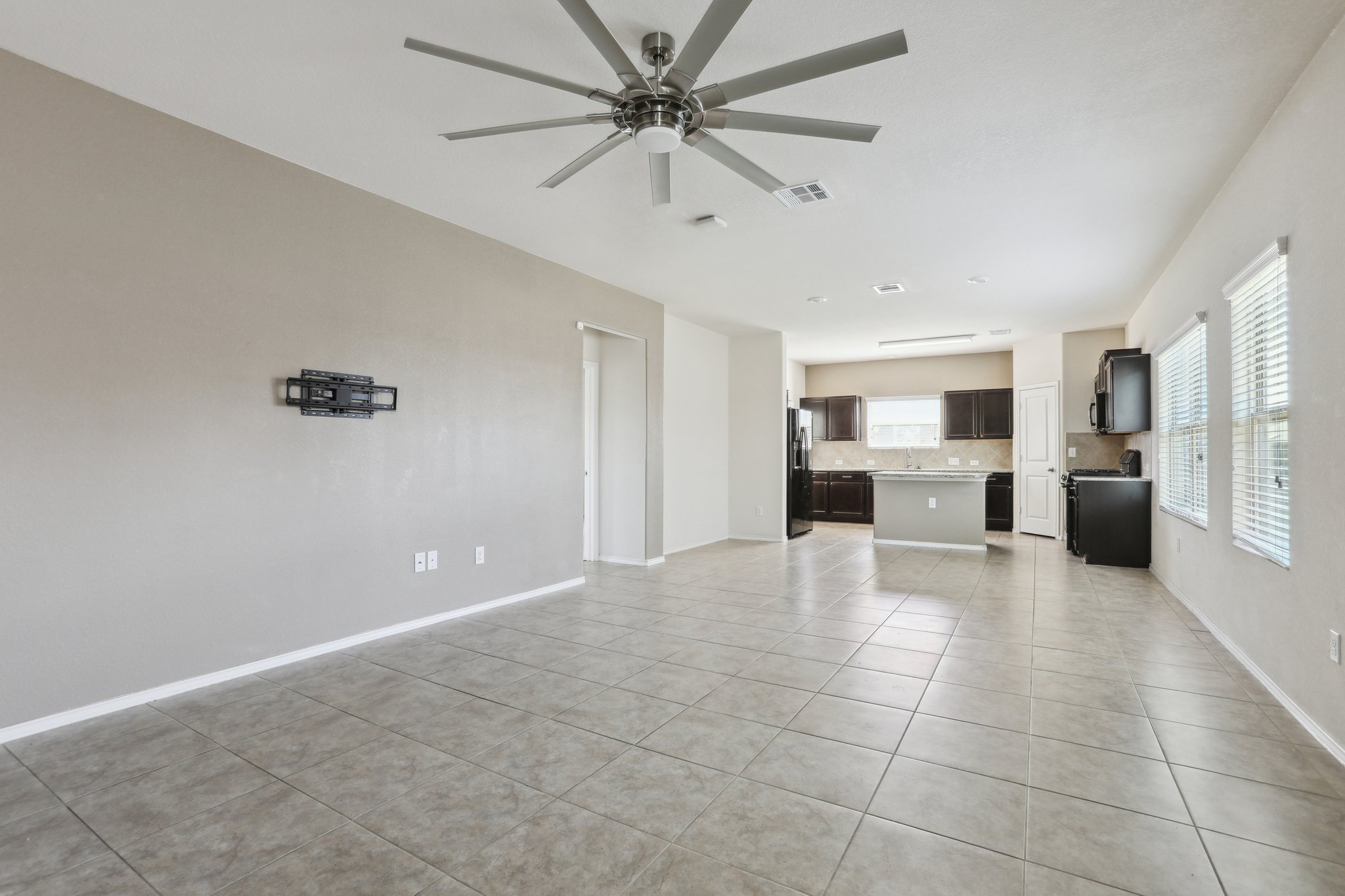 5713 Kennedy Street Austin, TX 78747 - Photo 6 of 30 Unfurnished living room featuring a ceiling fan and light tile patterned floors