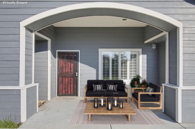 a living room with furniture and a potted plant
