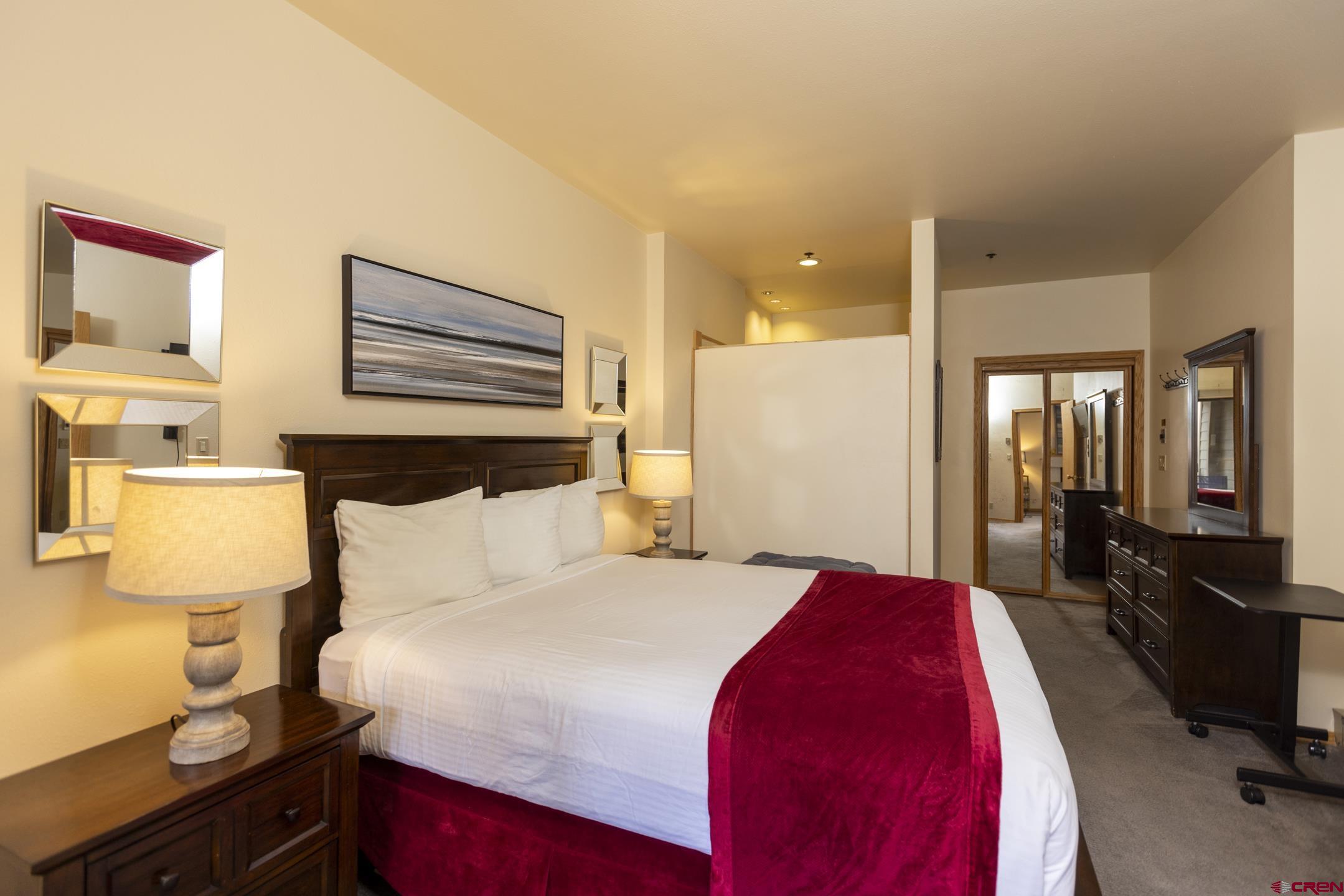 71 Needles Way, Unit 541 Durango, CO 81301 - Photo 11 of 32 a bedroom with a bed and a lamp on dresser
