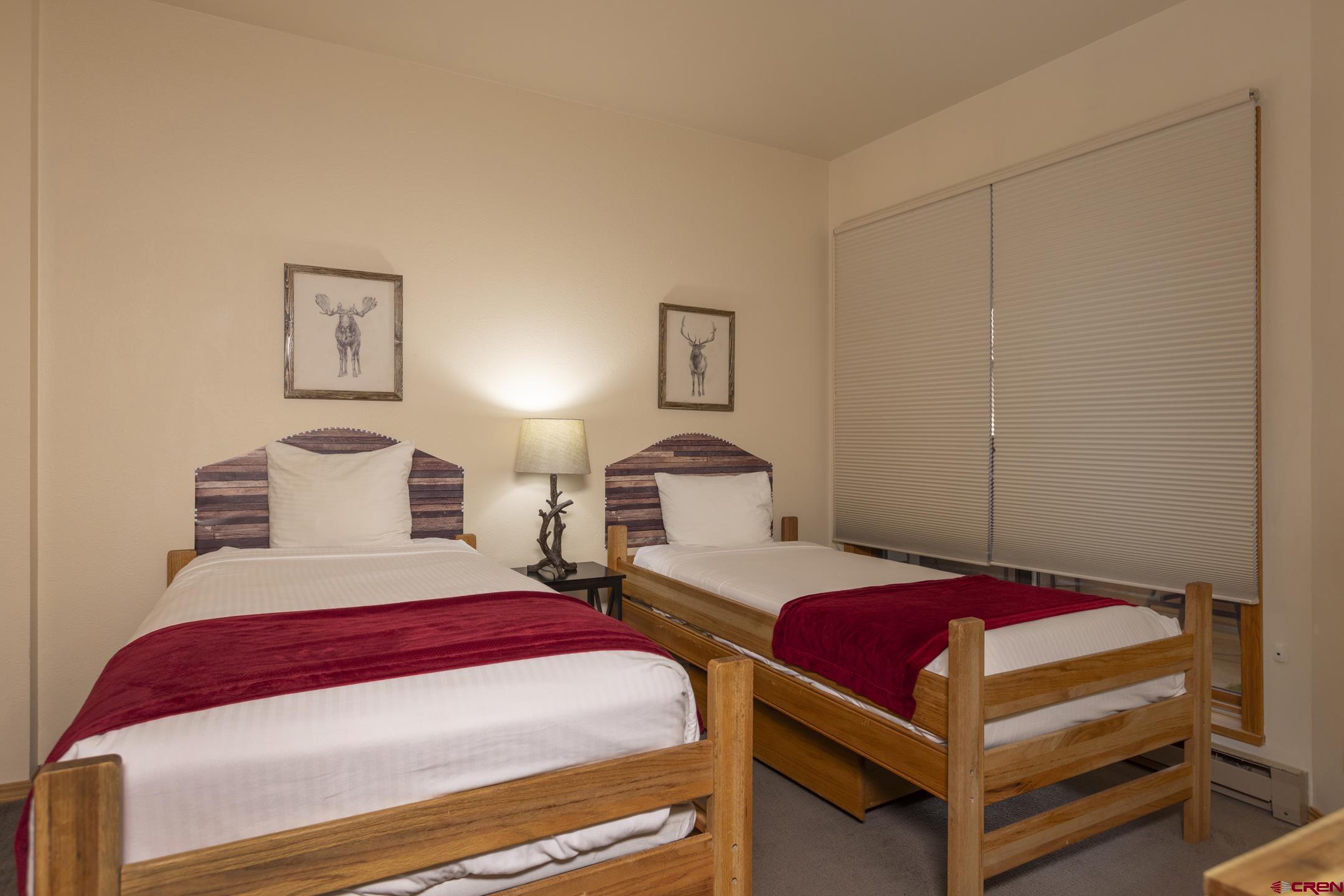 71 Needles Way, Unit 541 Durango, CO 81301 - Photo 16 of 32 a bedroom with a bed and lamp