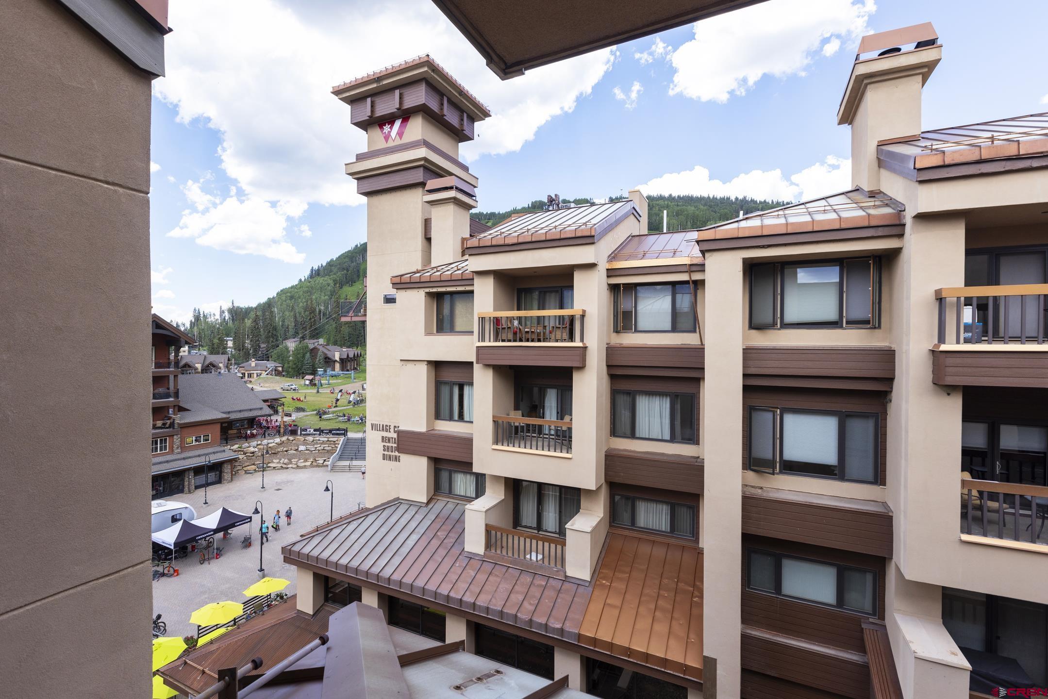 71 Needles Way, Unit 541 Durango, CO 81301 - Photo 18 of 32 a view of a brick building next to a yard
