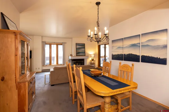 a view of a dining room with furniture and window