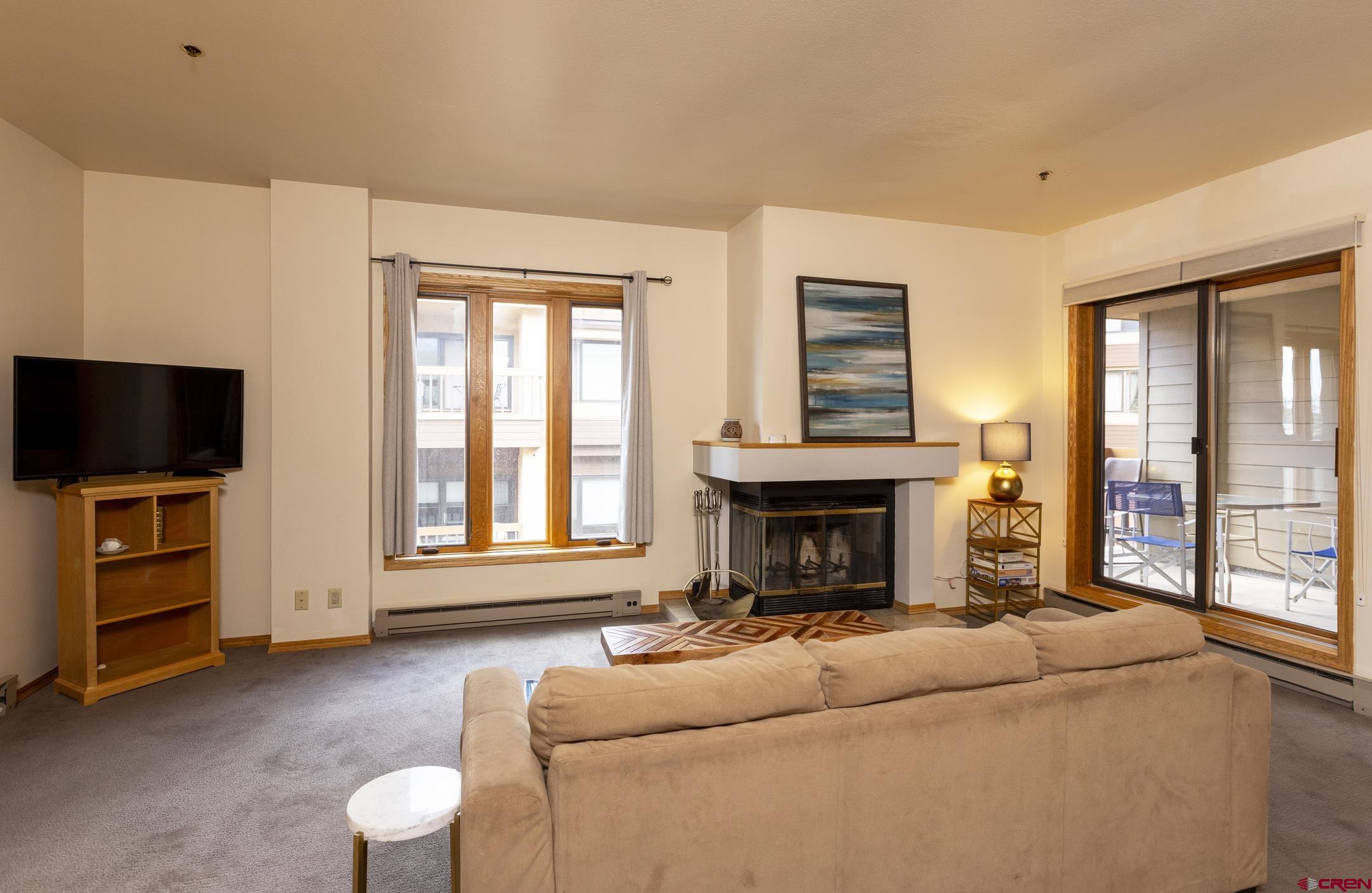 71 Needles Way, Unit 541 Durango, CO 81301 - Photo 7 of 32 a living room with furniture and a flat screen tv