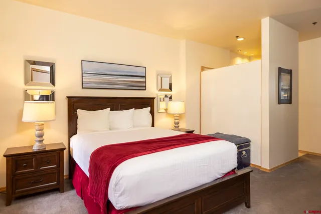 a bed room with a bed and a night stand