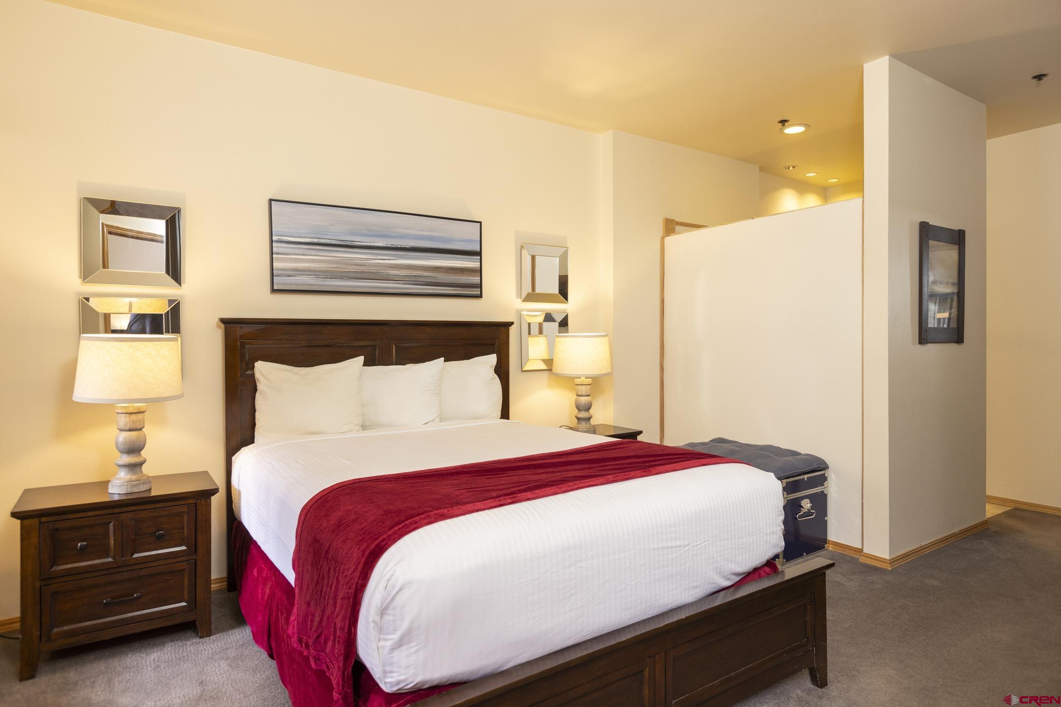 71 Needles Way, Unit 541 Durango, CO 81301 - Photo 9 of 32 a bed room with a bed and a night stand