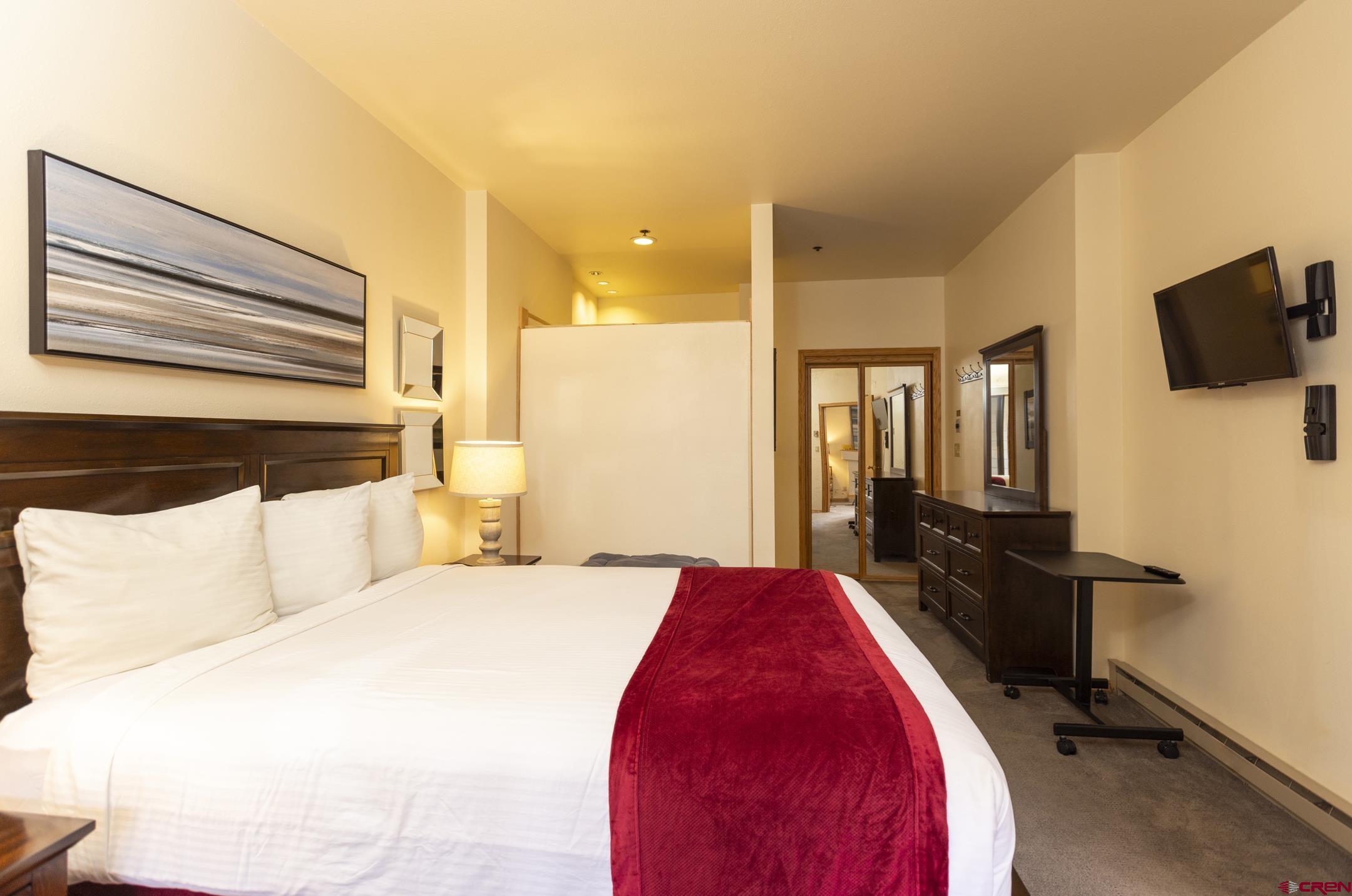 71 Needles Way, Unit 541 Durango, CO 81301 - Photo 10 of 32 a spacious bedroom with a bed and wooden floor