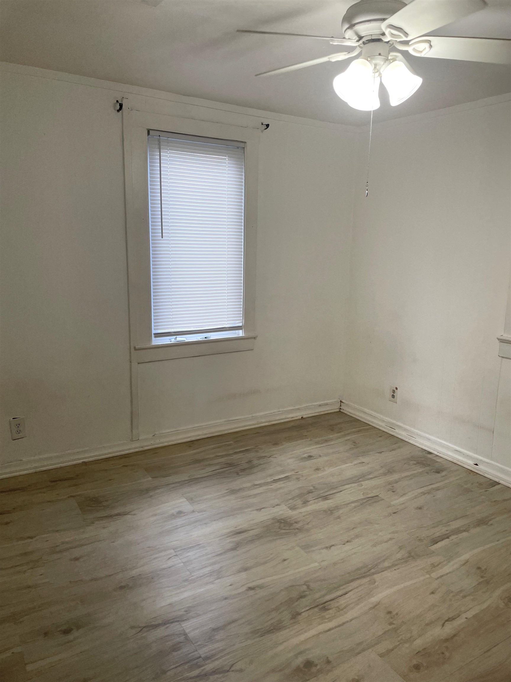 4588 First Avenue, Unit B St. Augustine, FL 32095 - Photo 5 of 8 a view of a room with wooden floor and a window