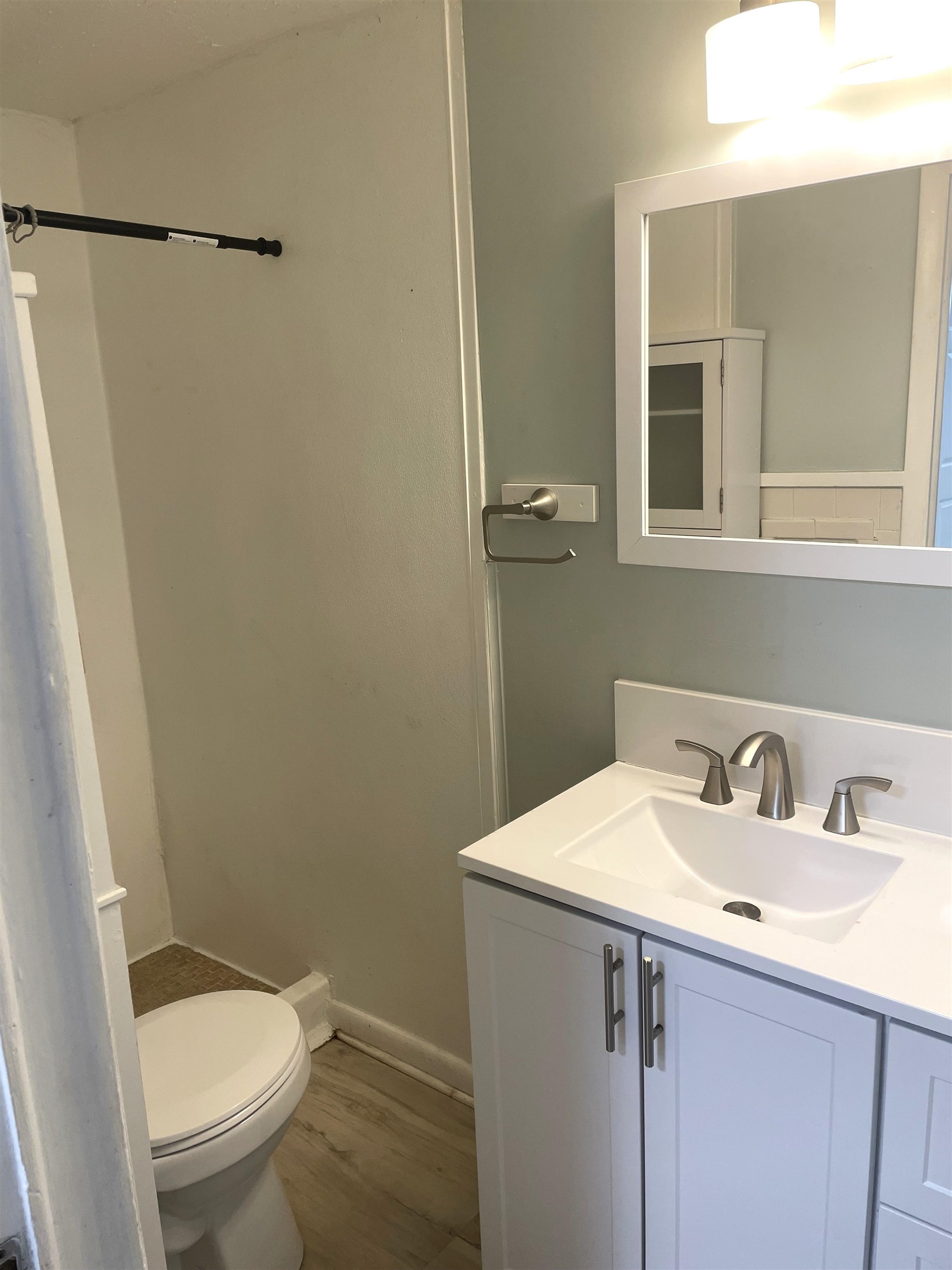 4588 First Avenue, Unit B St. Augustine, FL 32095 - Photo 8 of 8 a bathroom with a sink a toilet and a mirror