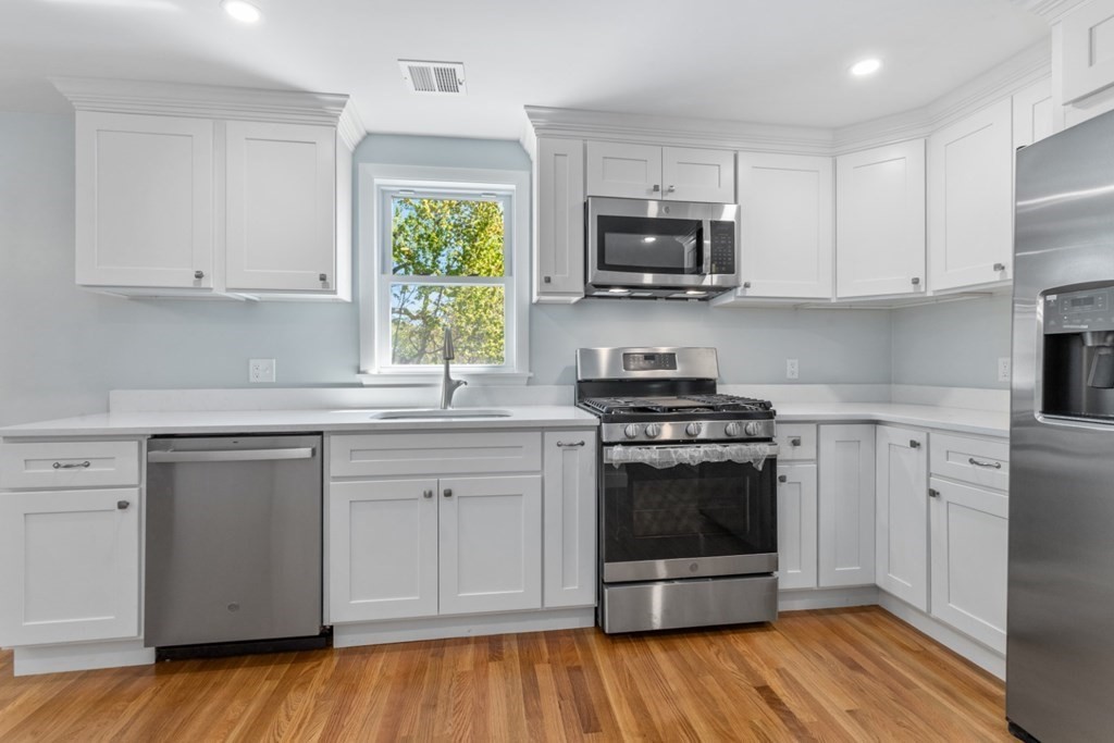32 Herbert Avenue Saugus, MA 01906 - Photo 3 of 35 a kitchen with stainless steel appliances a stove a sink and a microwave