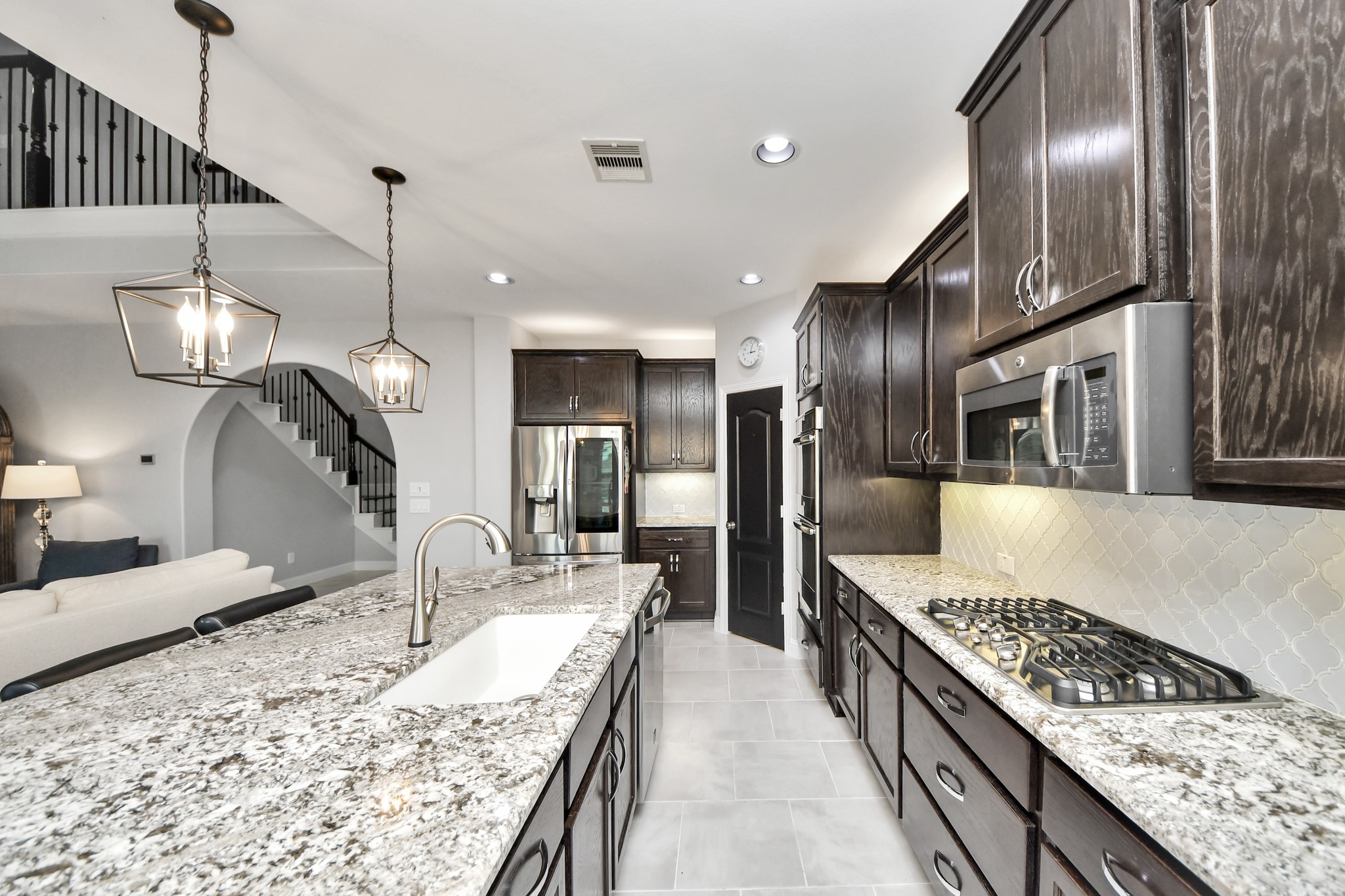 2811 Hadley Springs Lane Spring, TX 77386 - Photo 12 of 50 a large kitchen with stainless steel appliances kitchen island granite countertop a large counter top and a stove