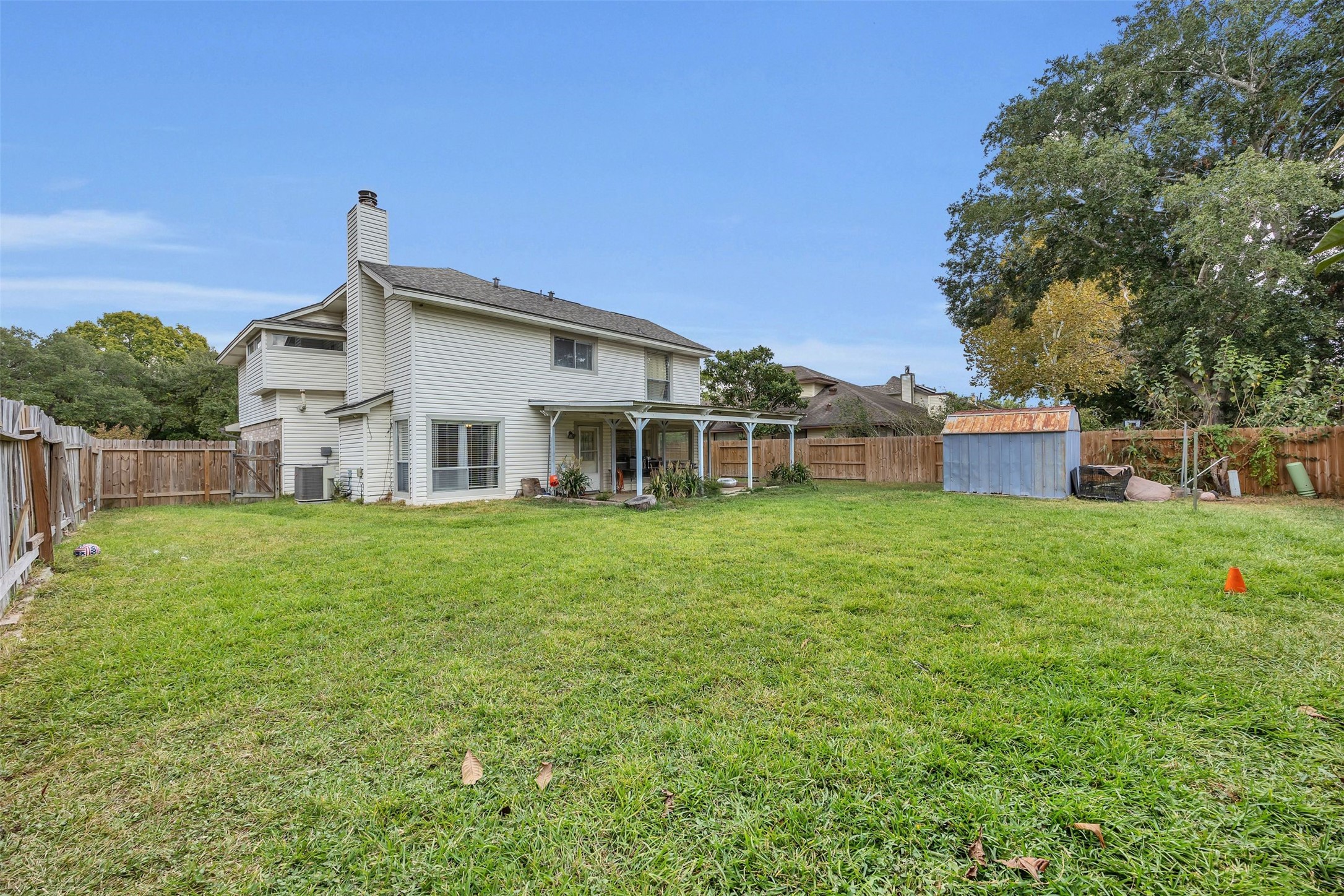15619 Beechnut Street Houston, TX 77083 - Photo 29 of 29 Enjoy the large covered patio, replaced fencing (2024), and plenty of room for outdoor gatherings.