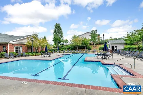 a view of a house with swimming pool and sitting area