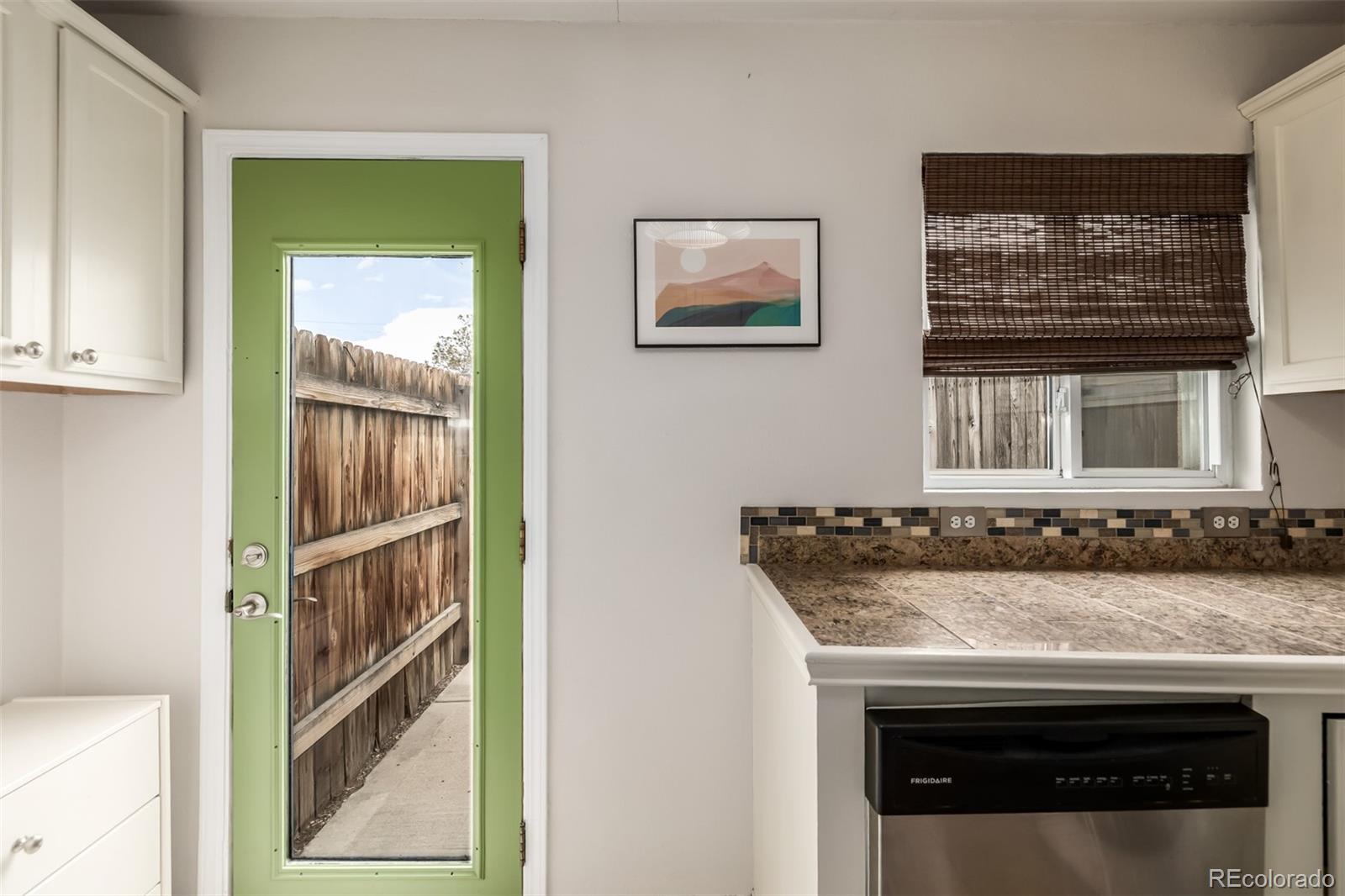 1800 Grove Street Denver, CO 80204 - Photo 11 of 35 a view of a kitchen that has a sink and a stove