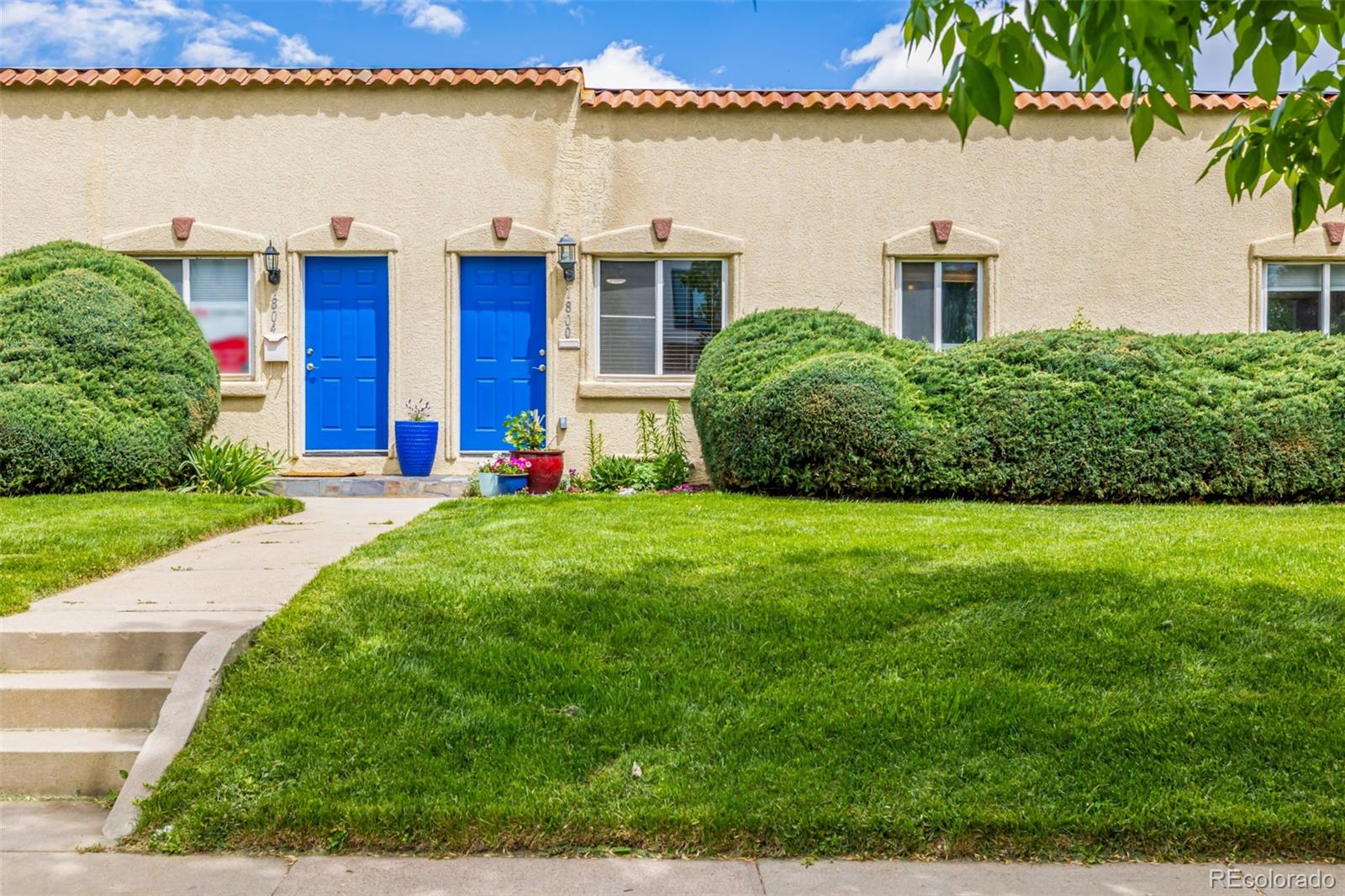 1800 Grove Street Denver, CO 80204 - Photo 2 of 35 a front view of a house with a garden and lake view