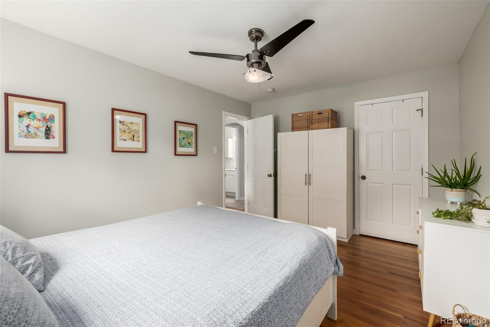 1800 Grove Street Denver, CO 80204 - Photo 7 of 35 a bedroom with a bed and a potted plant