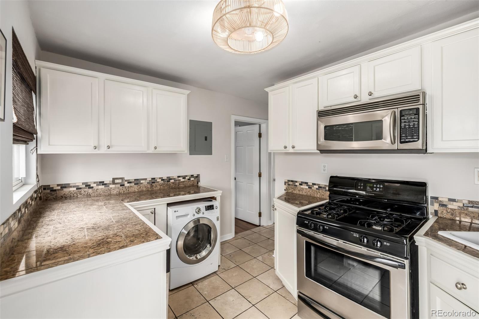 1800 Grove Street Denver, CO 80204 - Photo 10 of 35 a kitchen with granite countertop cabinets stainless steel appliances and a sink