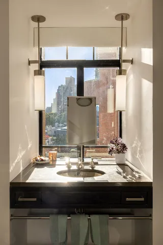 a kitchen with stainless steel appliances granite countertop a stove a sink dishwasher a refrigerator a oven with white cabinets and wooden floor