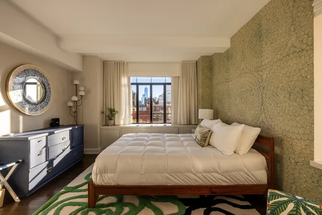 a bedroom with a bed and a table with chair