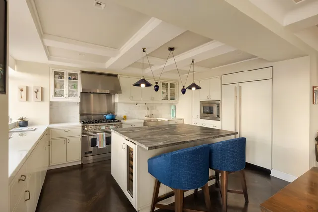 a kitchen with a sink a center island and a counter space