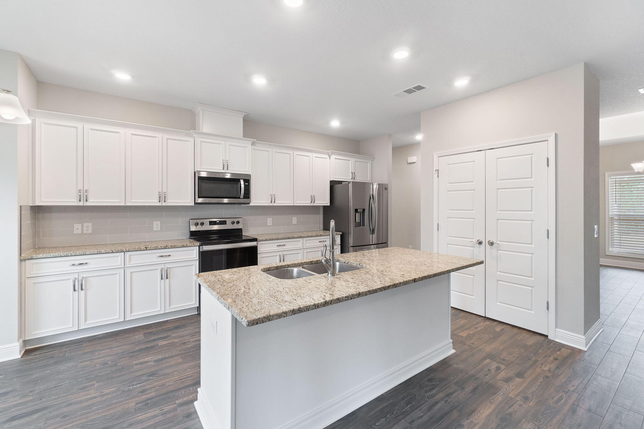 7745 Tidwell Road Pace, FL 32571 - Photo 14 of 57 a kitchen with stainless steel appliances granite countertop a sink a stove a refrigerator and cabinets