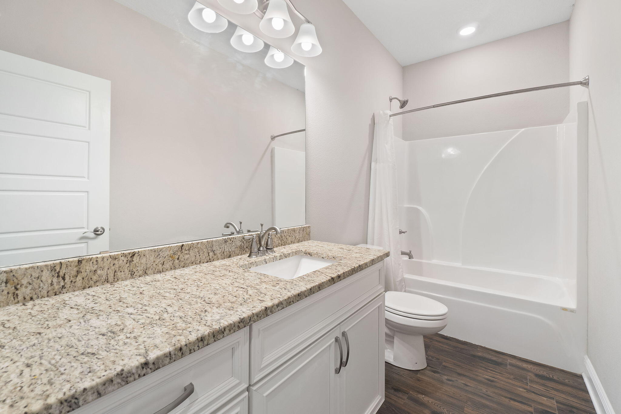 7745 Tidwell Road Pace, FL 32571 - Photo 20 of 57 a bathroom with a granite countertop sink a toilet and bathtub