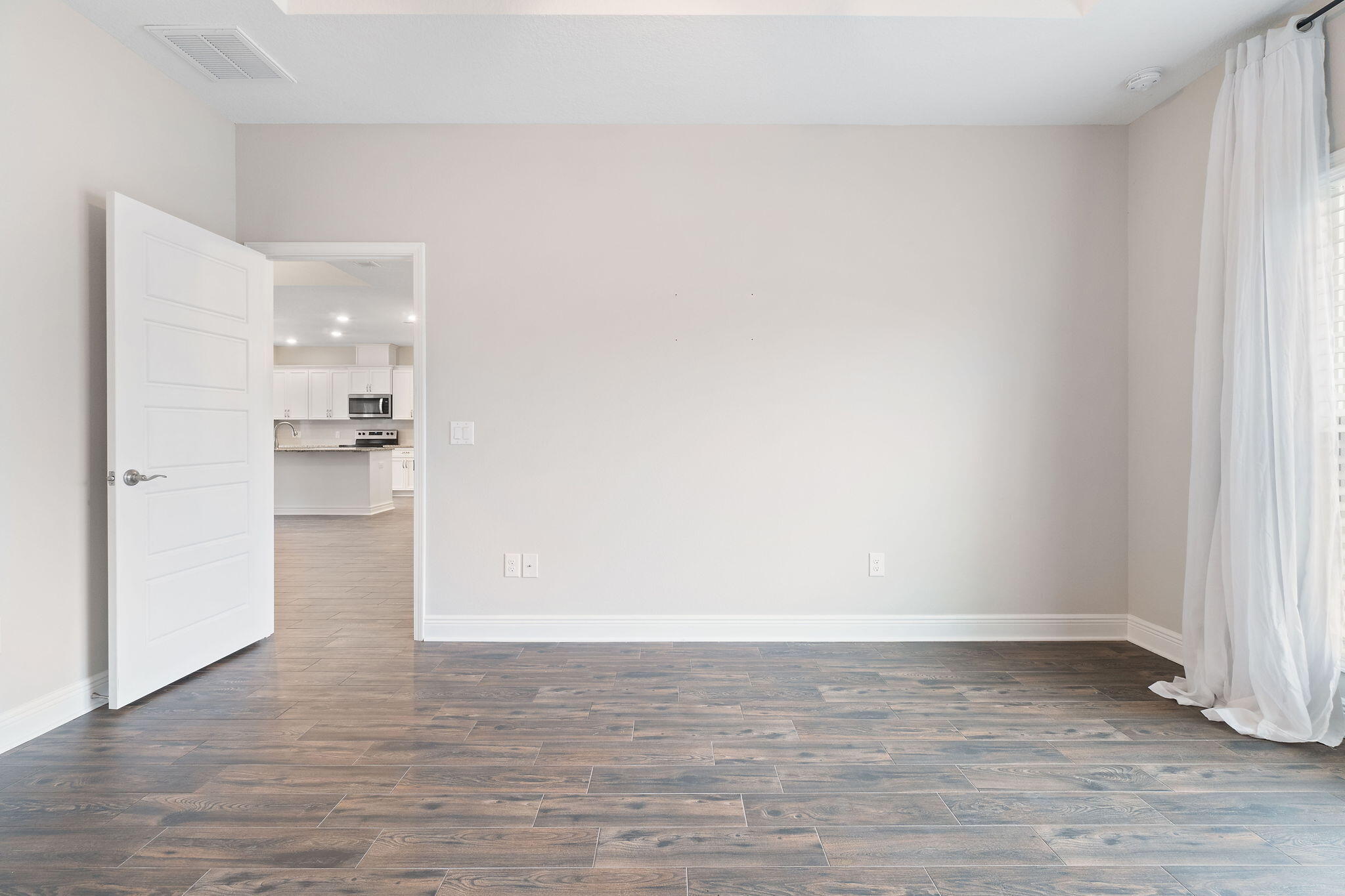 7745 Tidwell Road Pace, FL 32571 - Photo 26 of 57 a view of an empty room and wooden floor