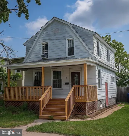 a view of a house with a yard and a porch