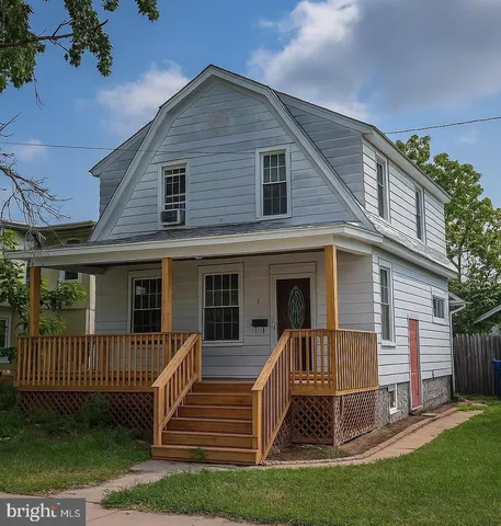 a view of a house with a yard and a porch