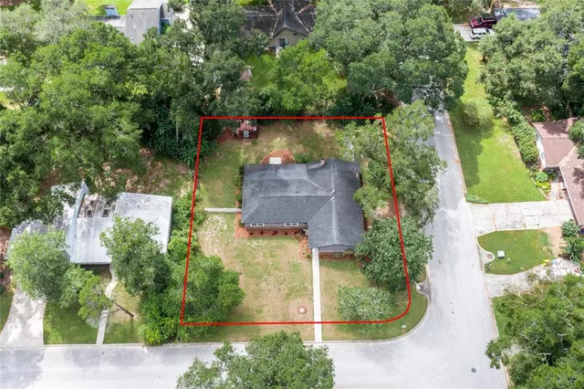 an aerial view of a house with a yard and lake view