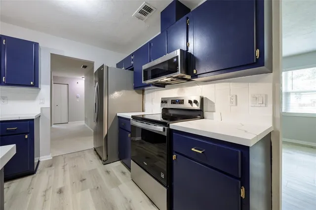 a kitchen with stainless steel appliances a refrigerator and a sink