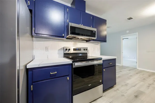 a view of empty room with a fireplace