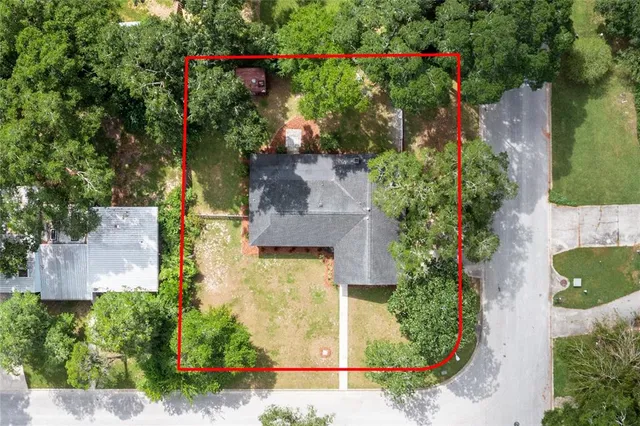 an aerial view of a house with a yard and garden