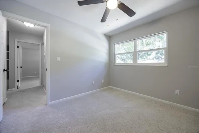 a bath tub sitting next to a white toilet and a shower