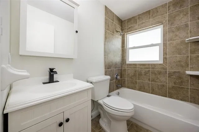 an empty room with closet and a chandelier fan