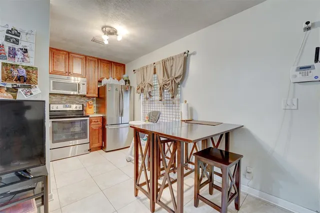 a kitchen with stainless steel appliances a stove a refrigerator and countertop