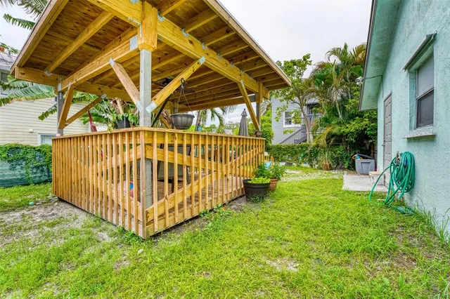 a view of backyard with a garden and deck