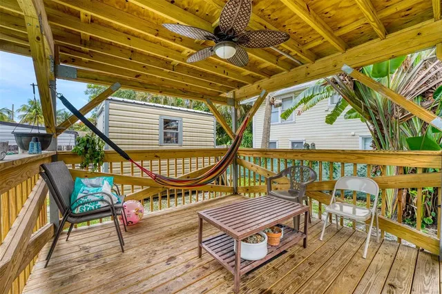 a balcony with wooden floor outdoor seating and outdoor space